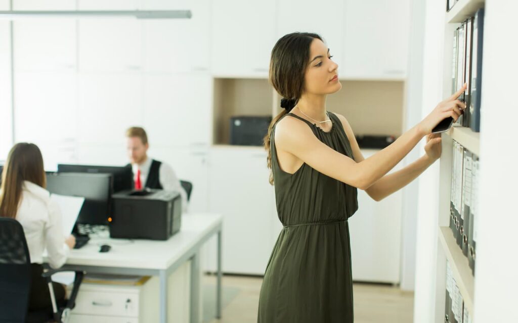 Woman looking through office files